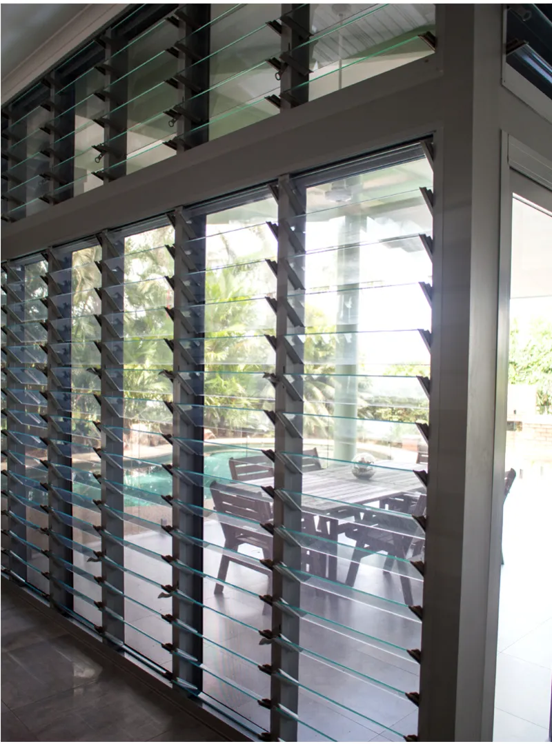 Glass louvre windows looking out to a tropical garden